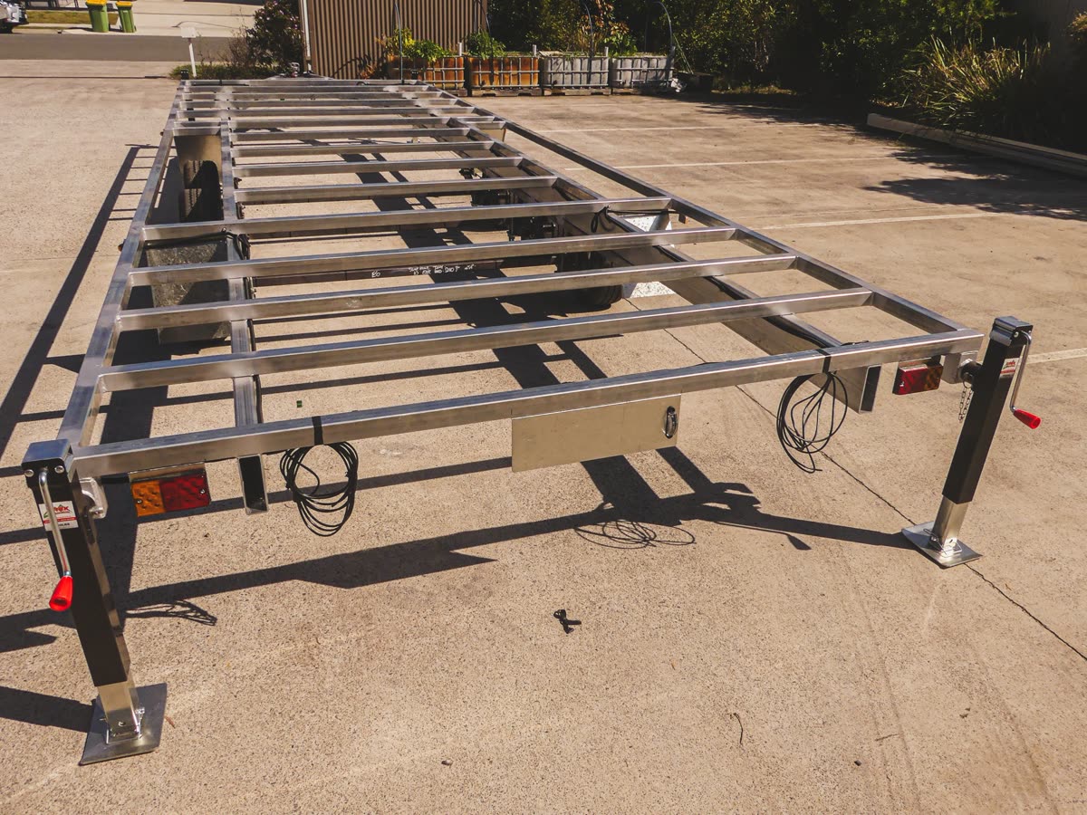 Custom tiny house trailer — low-profile wheels and mudguards